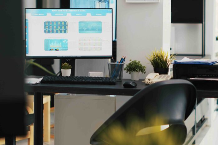 Empty company financial department with stock portfolio on computer monitor containing collection of investment assets. Workspace with live index indices on PC screen showing stock demand surge